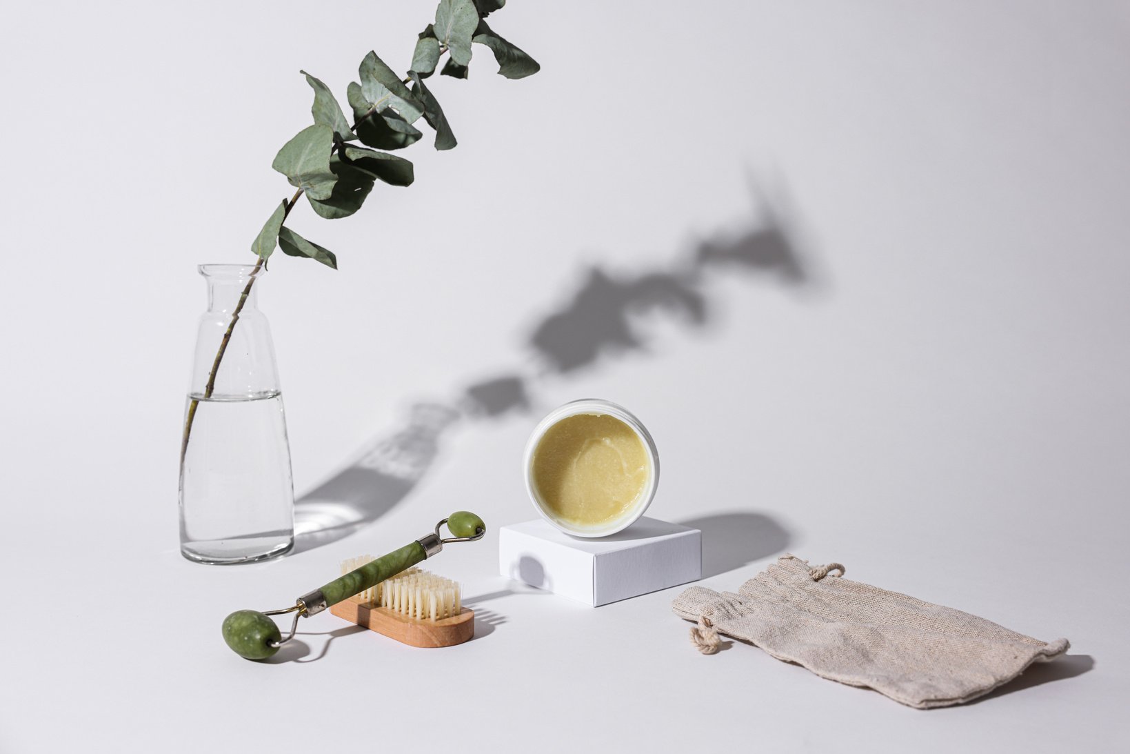 Close-up Photo of Beauty Product and a Facial Roller 